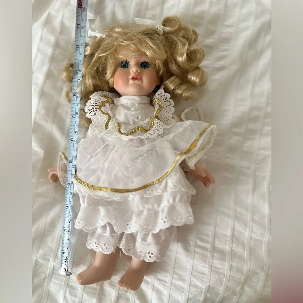 Victorian style porcelain doll with curly blond hair